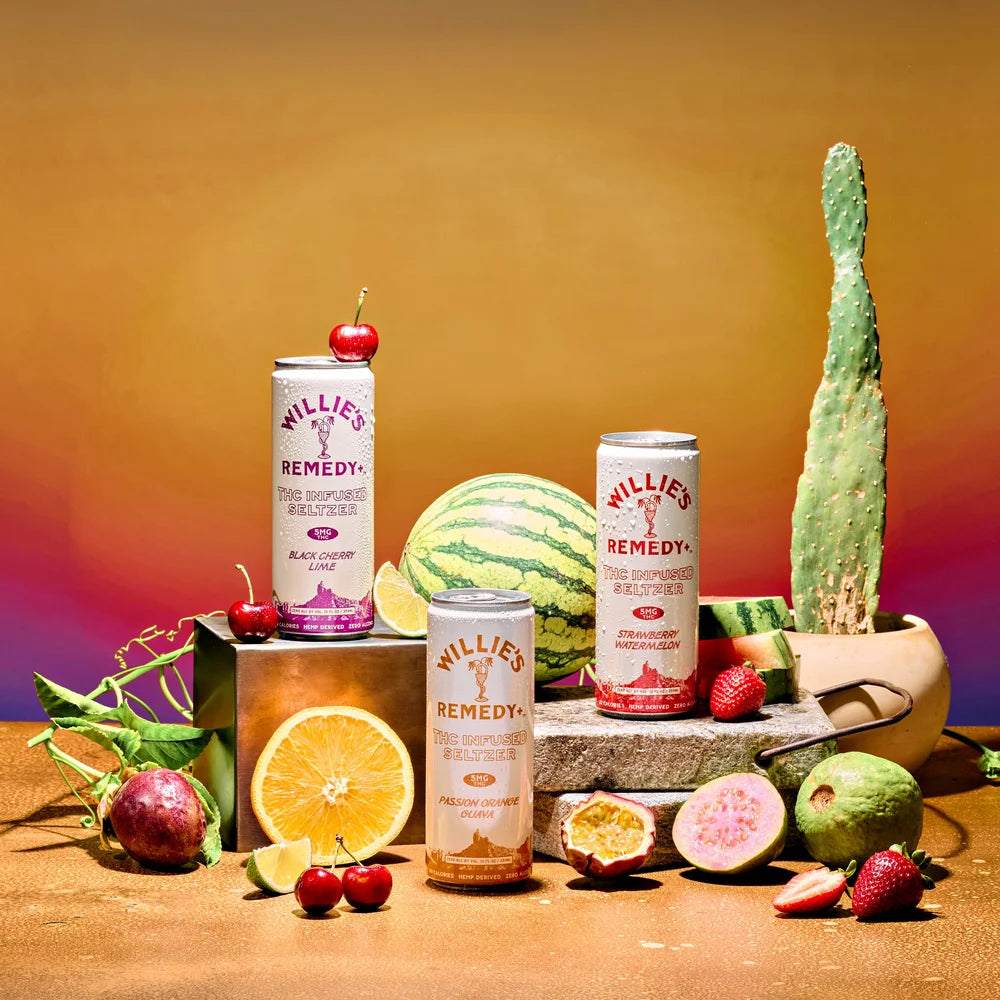 Willie's Remedy+ cans with fruits and a cactus on a colorful background