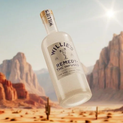 Bottle of 'Willie's Remedy' THC-infused product with desert landscape in the background