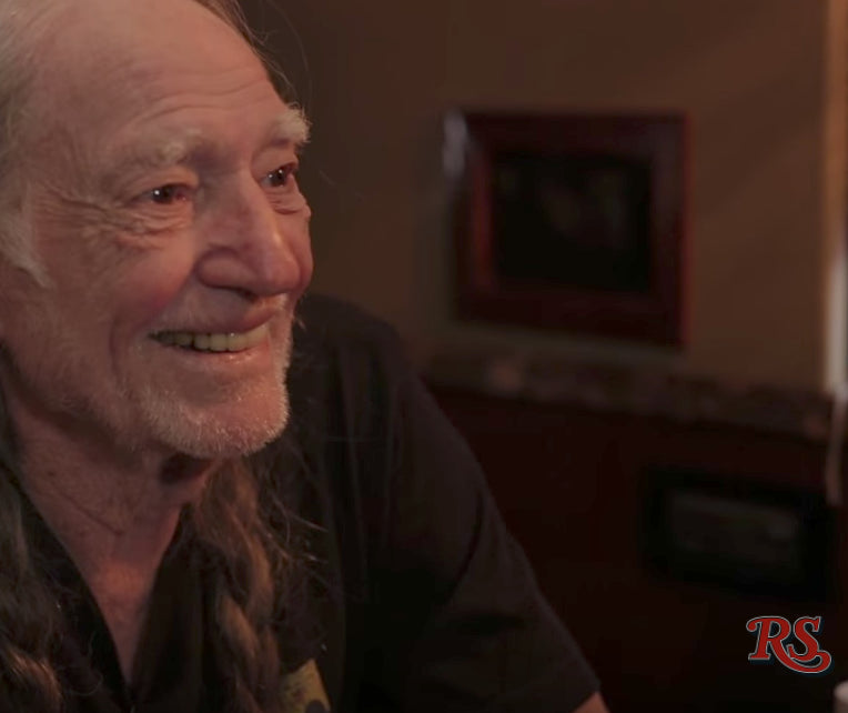 Close-up of Willie Nelson with a warm smile indoors