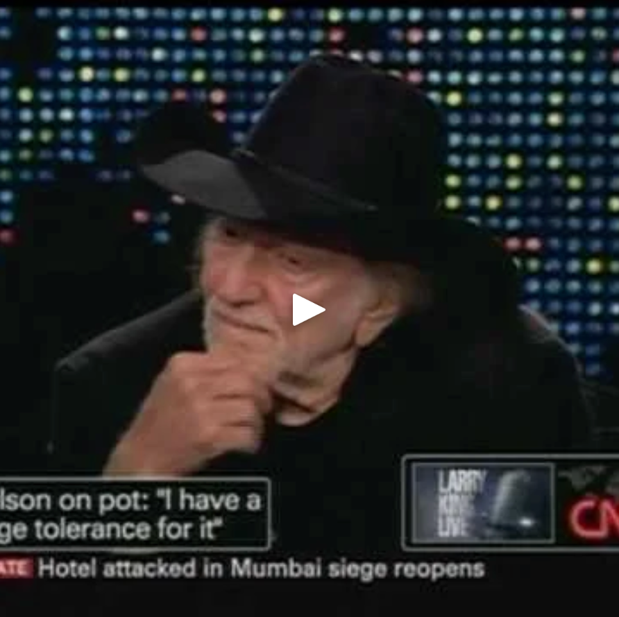 Willie Nelson wearing a black cowboy hat on a television screen with a CNN logo.